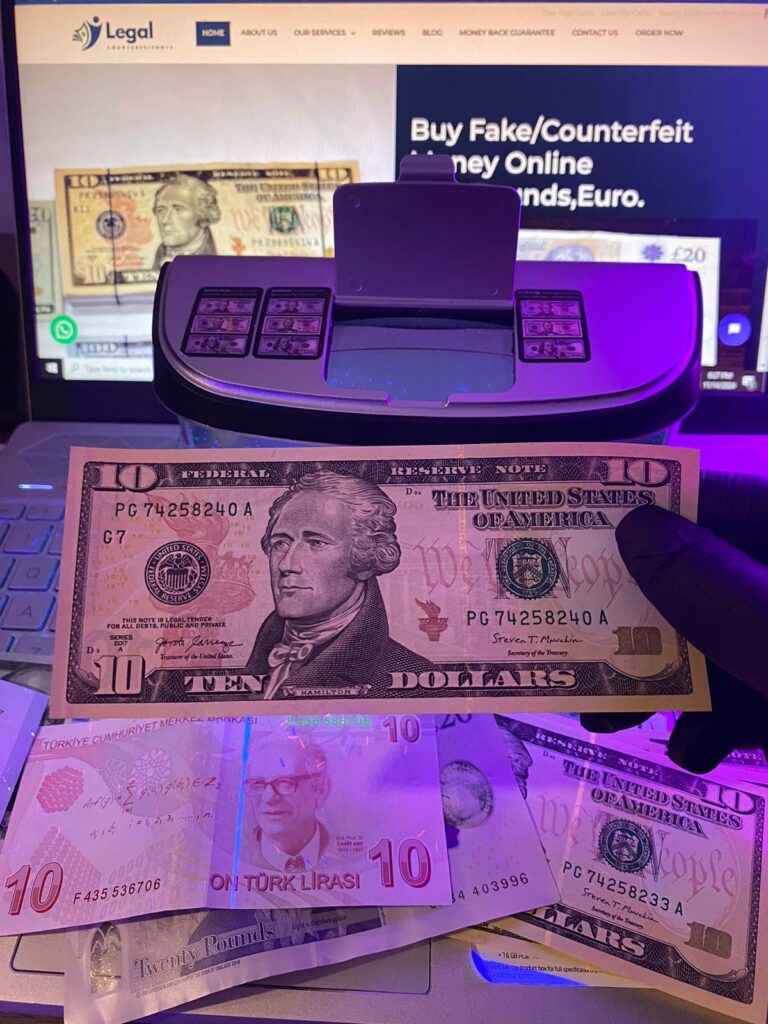 Counterfeit dollar bills being tested with a counterfeit money scanner